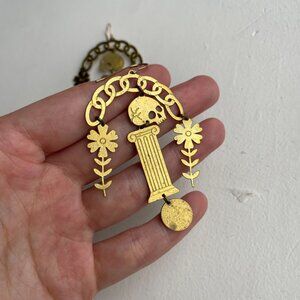 while odin sleeps brass "adventum" skull pedestal dangle earrings